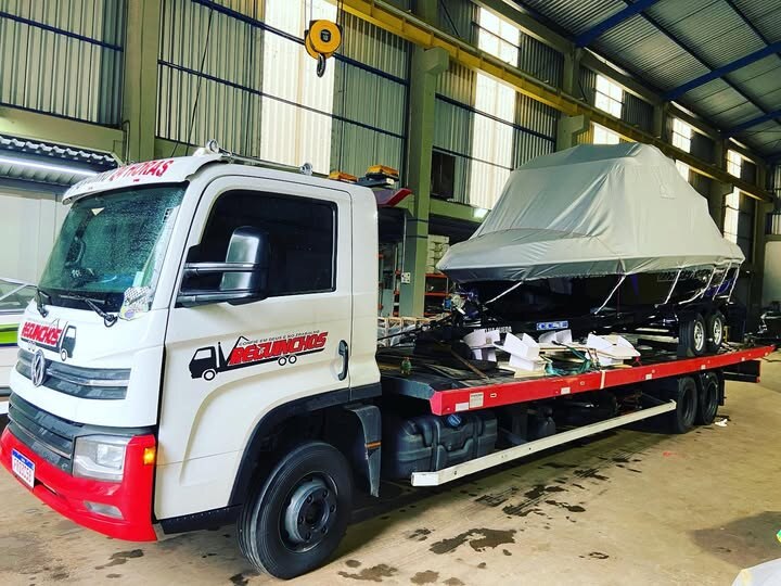 Guincho plataforma transportando embarcação em galpão